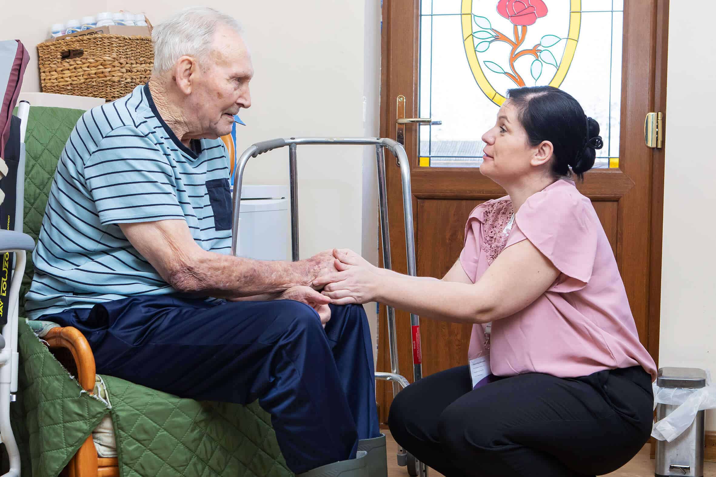 Image of carer helping resident